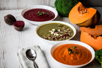 Different vegan food. Colorful vegetables cream soups and ingredients for soup. Healthy eating, dieting, vegetarian kitchen and cooking concept.