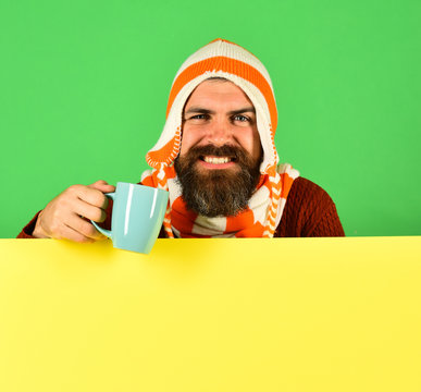 Hipster with beard and happy face has coffee
