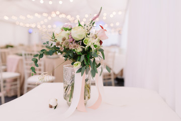 Floral bouquet for the wedding ceremony in transparent vase, landscape