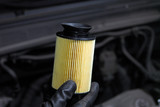 mechanic in the hand, remove car oil filter