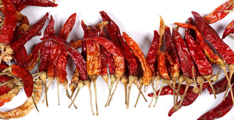 Dry red hot chili peppers, pile isolated on white background, top view