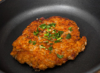 big and juicy meat burger cutlet on iron pan