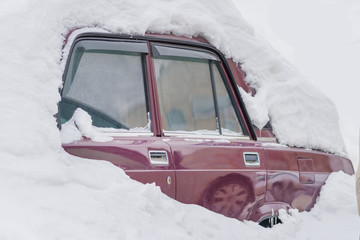 Old red car in the snowdrift