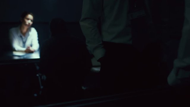  Detectives giving tough questioning to crime suspect at police station