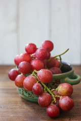ceramic bowl filled by bunch of fresh grapes