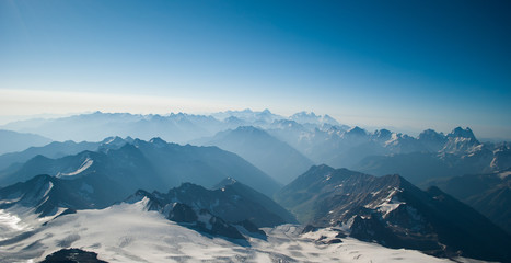 mountains in the mist at sunrise, above the clouds