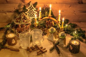 Traditional mulled wine in glasses. Christmas decoration and ornaments on wood background. Festive Christmas alcoholic drink in an atmospheric environment