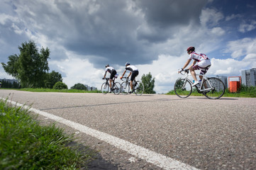three bikers by race cycling contest