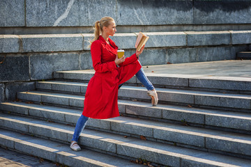 ballerina drink coffee and read book in city