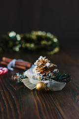 Christmas decoration with pinecone on wooden board.