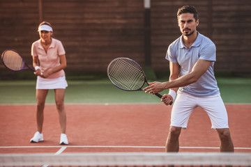 Couple playing tennis