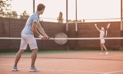 Zelfklevend Fotobehang Couple playing tennis © georgerudy