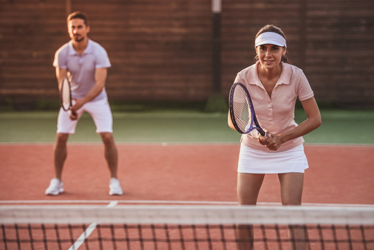 Couple playing tennis