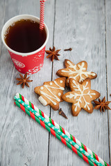 Red cup of tea and Christmas cookies on the grey wooden  table