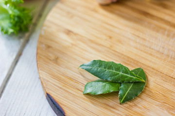 Bay leaves over wooden board