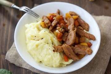 Soy meat with potato puree over kitchen table.