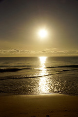 Fototapeta premium Early Morning Sunrise on Waimanalo Beach on Oahu, Hawaii over the clouds