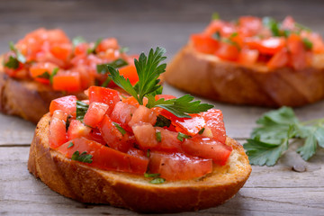 Tasty bruschetta with tomatoes and herbs