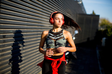Active young beautiful woman running in urban enviroment