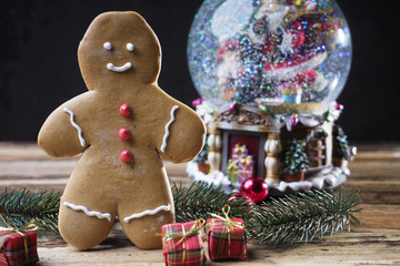 gingerbread man with christmas gifts and snow-globe