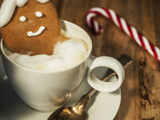 gingerbread man bathing in a cup of coffee
