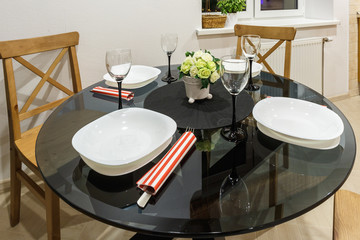 Bouquet of flowers on a table with cutlery on four person