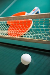 Table Tennis Rackets and Ball on Table with Net