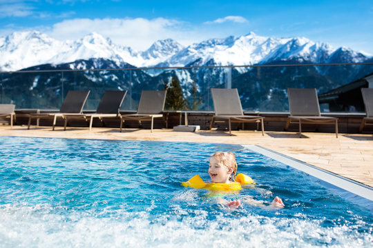 Child in outdoor swimming pool of alpine resort