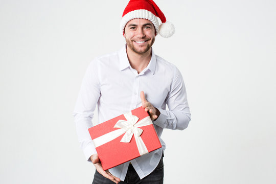 Cheerful happy man with gift. Santa helper.