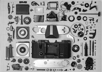 parts old retro film SLR camera on graph paper