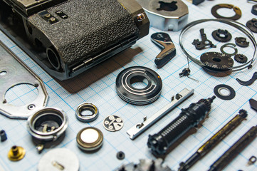 parts old retro film SLR camera on graph paper
