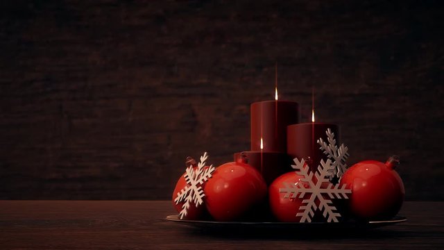 Drei Kerzen mit Kugeln und festlicher Dekoration vor einem Holz Hintergrund