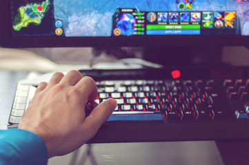 Man's hand plays PC game