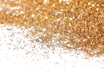 Golden festive glitter background with defocused lights