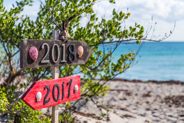 2018 and 2017 metal numbers on the wood board at the beach path.