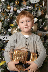 Red-haired boy with a Christmas gift