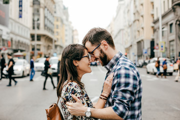 .A young couple in love walking around Madrid and enjoying a very fun day of sightseeing around the...