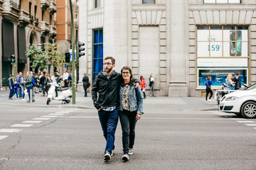 .A young couple in love walking around Madrid and enjoying a very fun day of sightseeing around the city center. Travel photography. Lifestyle