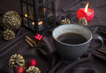 Obraz na płótnie Canvas Christmas setting coffee cup and decorations, candles, lantern