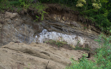 Scree large pieces of clay bank of the river