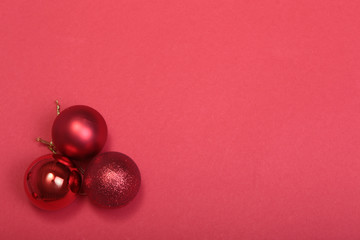 Red christmas balls on a red background
