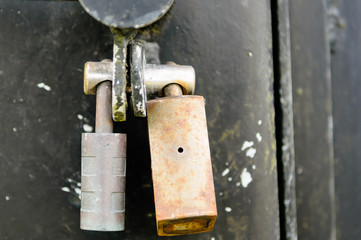 Two padlocks on a gate bolt, enabling the gate to be opened by unlocking any one padlock