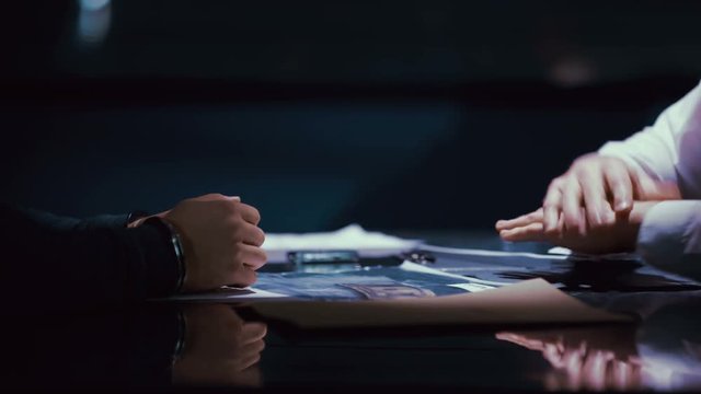 Criminal in handcuffs being interrogated by police officer 