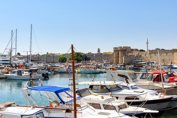 Port of Rhodes town with moored fishing boats near the pier.