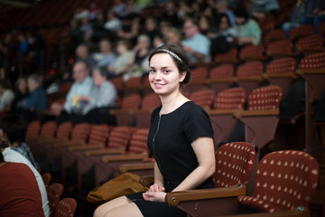 female in black dress at theatre