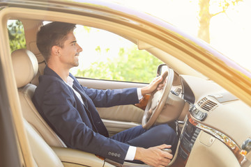 Young businessman driving a car