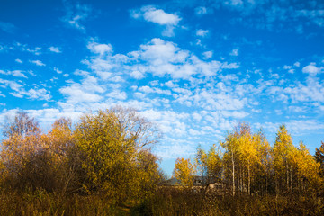Fototapeta premium Village and clouds above it on the blue sky