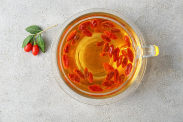 Cup with goji tea on table