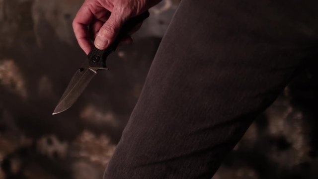 TOUGH GUY PULLS A KNIFE, CLOSE UP IN 4K.