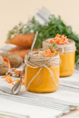 Carrot pudding with crushed nuts is served in a glass jar..